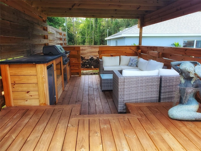 wooden deck with outdoor lounge area and a grill