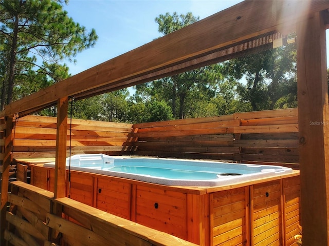 view of swimming pool featuring a hot tub