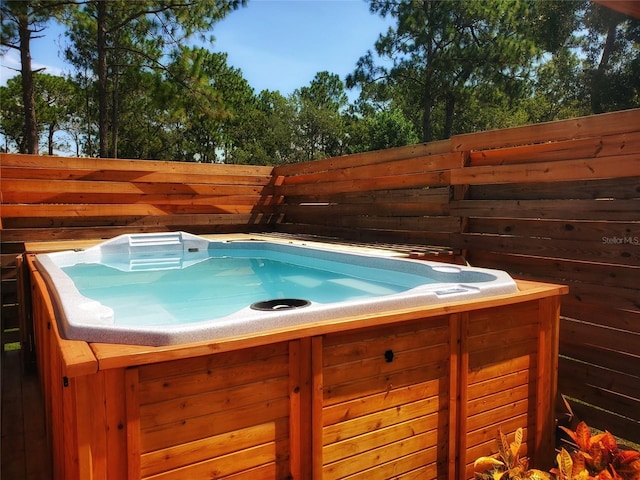 view of pool with a hot tub