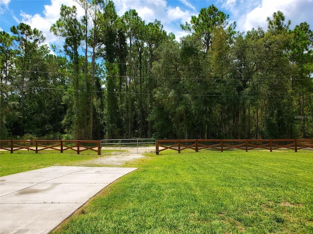 view of yard featuring a view of trees and fence