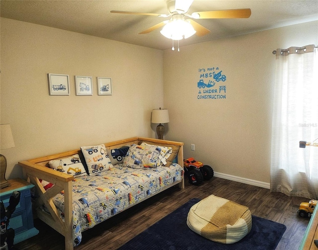 bedroom featuring wood finished floors, baseboards, and ceiling fan