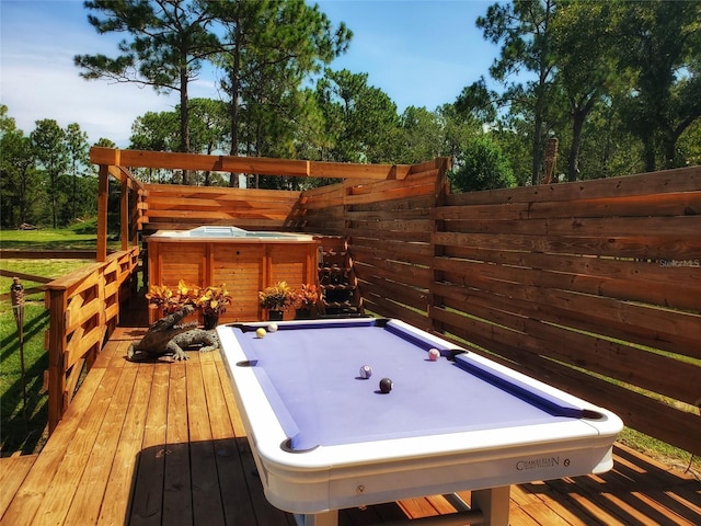 deck with an outdoor hot tub