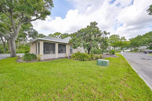 view of yard featuring a sunroom