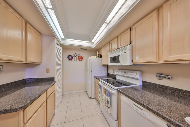 kitchen with white appliances, light brown cabinetry, light tile patterned floors, crown molding, and dark stone countertops