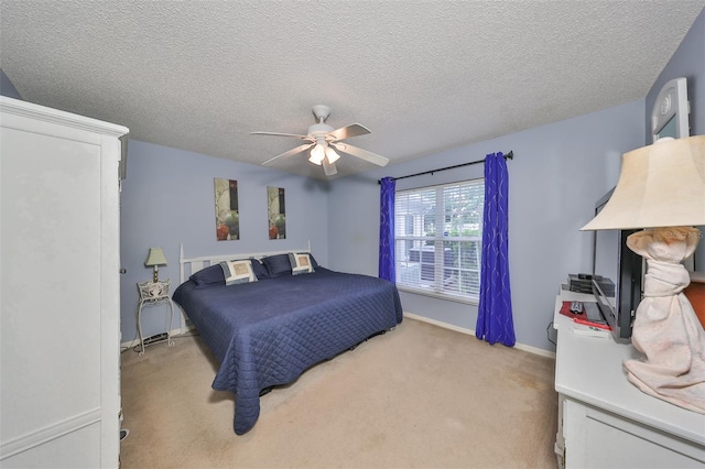 carpeted bedroom featuring ceiling fan and a textured ceiling