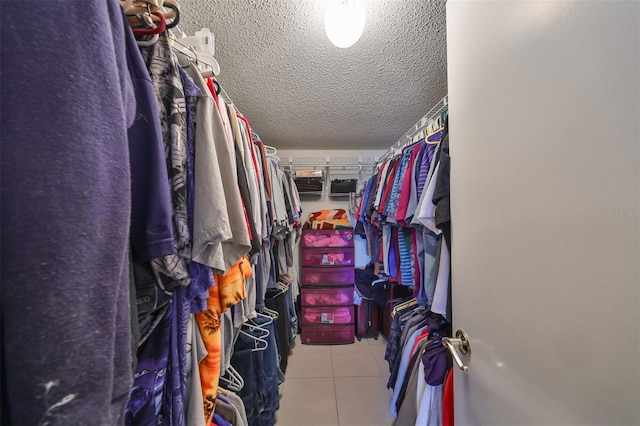 spacious closet with light tile patterned flooring