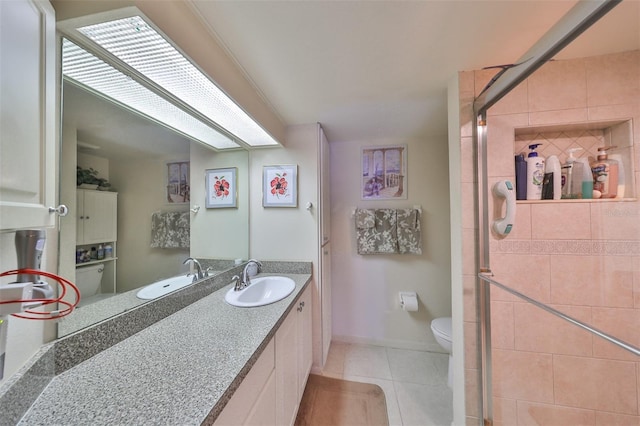 full bathroom featuring vanity, baseboards, tile patterned flooring, a shower stall, and toilet