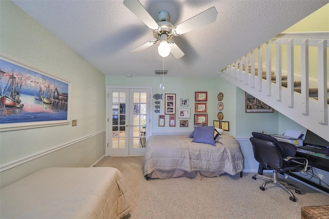 carpeted bedroom with visible vents, baseboards, ceiling fan, french doors, and a textured ceiling