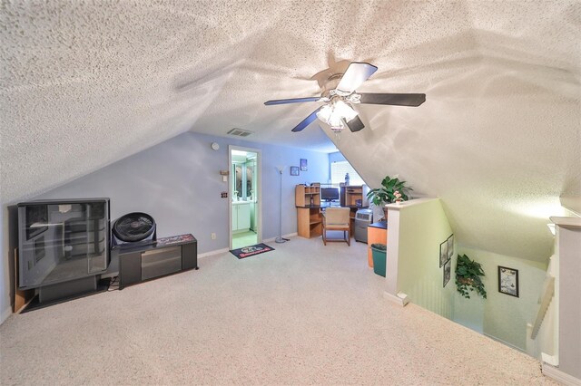 additional living space featuring ceiling fan, carpet floors, vaulted ceiling, and a textured ceiling