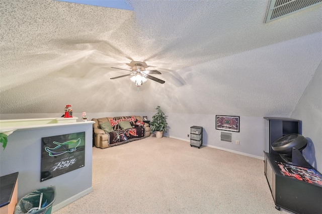 interior space featuring visible vents, a textured ceiling, a ceiling fan, and vaulted ceiling