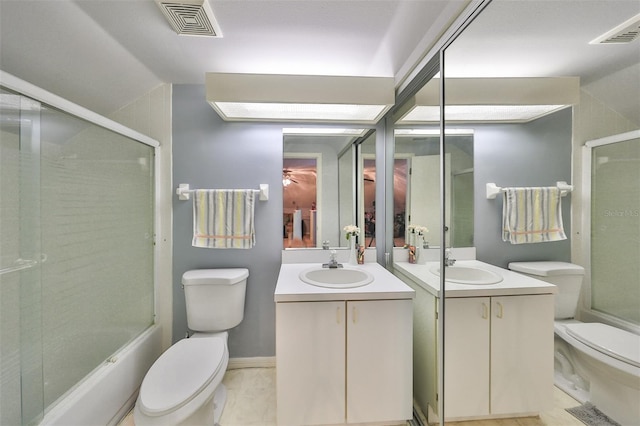 full bathroom featuring shower / bath combination with glass door, tile patterned flooring, toilet, and vanity