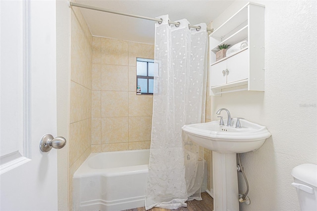 bathroom featuring shower / tub combo with curtain, toilet, and hardwood / wood-style floors