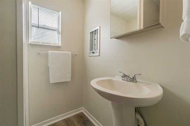 bathroom with hardwood / wood-style flooring and sink