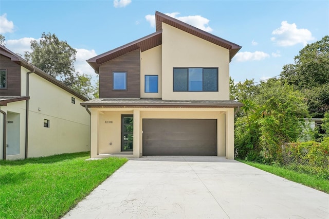 contemporary house featuring a garage and a front yard