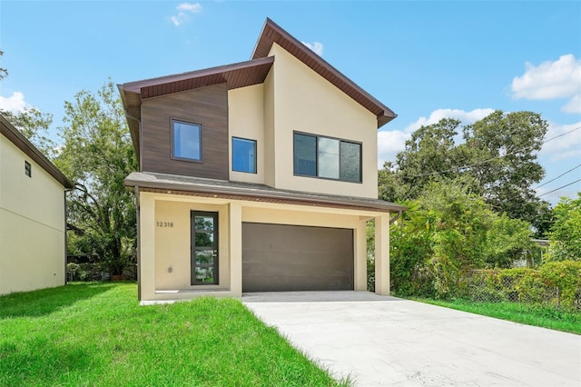 contemporary house featuring a garage and a front lawn