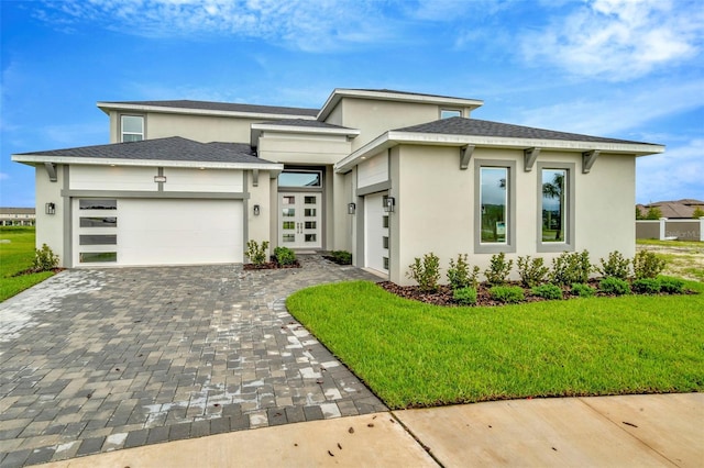 prairie-style house with a front yard and a garage