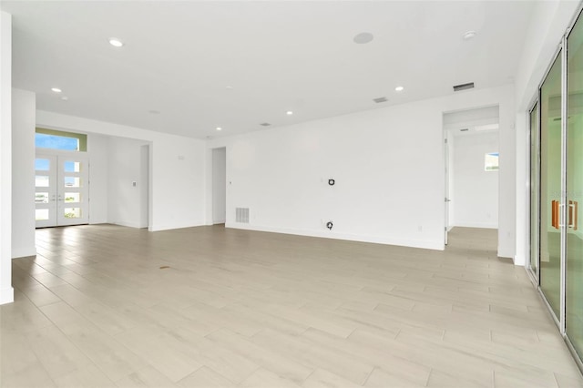 unfurnished room with recessed lighting, french doors, and visible vents