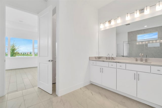 bathroom with marble finish floor, a sink, double vanity, baseboards, and walk in shower