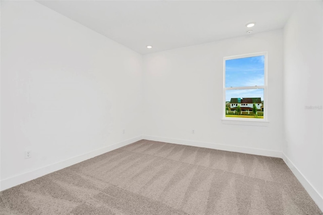 carpeted spare room with recessed lighting and baseboards