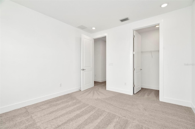 unfurnished bedroom with recessed lighting, visible vents, carpet floors, and baseboards