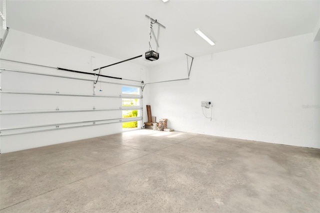 garage with concrete block wall and a garage door opener