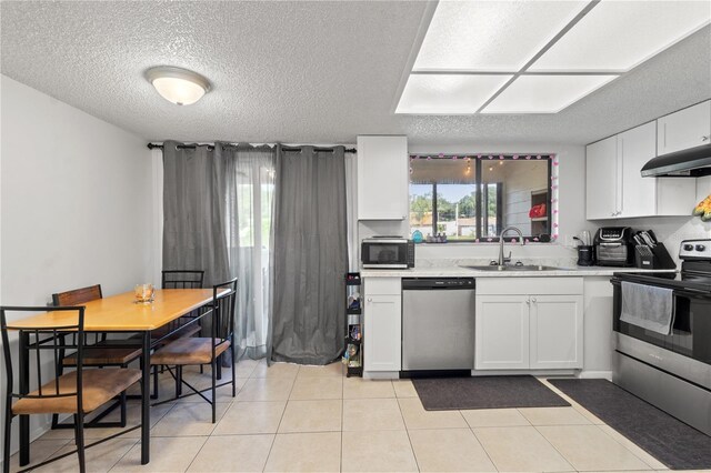 kitchen with white cabinets, plenty of natural light, stainless steel appliances, and sink