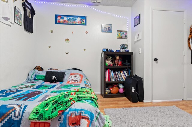 bedroom with hardwood / wood-style floors