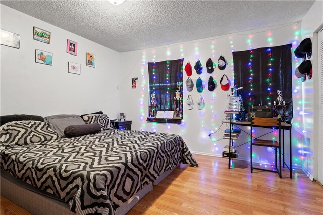 bedroom featuring a textured ceiling and hardwood / wood-style floors