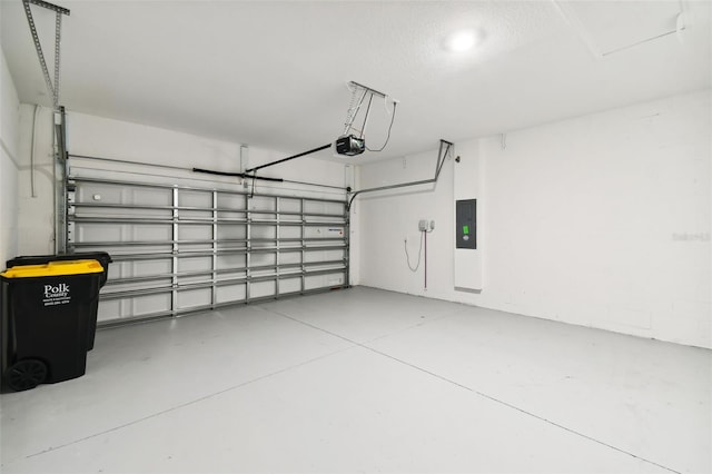 garage featuring electric panel and a garage door opener