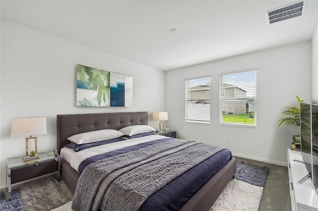 bedroom with visible vents, baseboards, and carpet