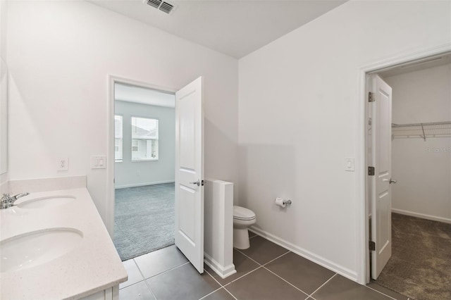 full bathroom featuring tile patterned floors, visible vents, toilet, and a sink