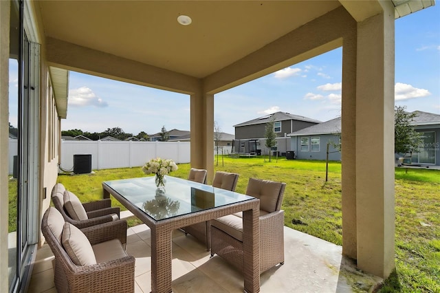 view of patio / terrace with outdoor dining area, fence, and a residential view