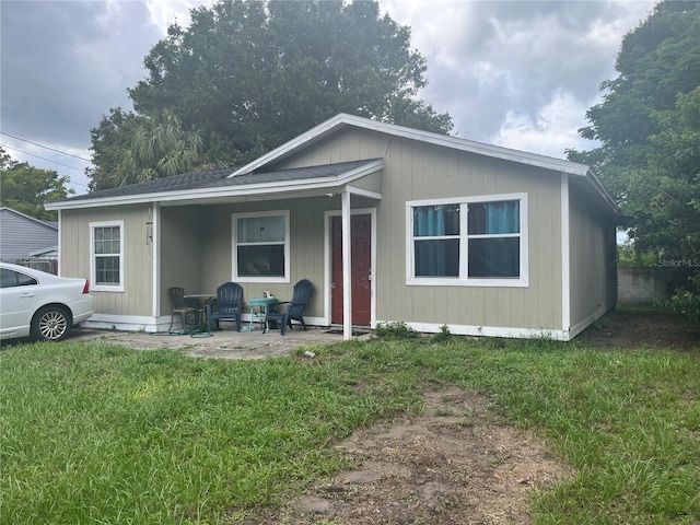 view of front of property with a front yard and a patio area