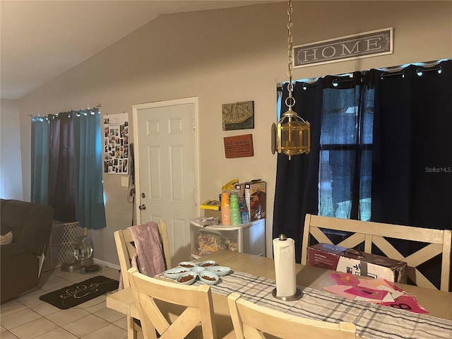 tiled dining area featuring lofted ceiling