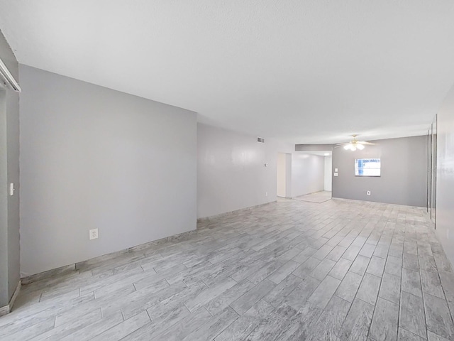 spare room featuring ceiling fan and light wood-type flooring