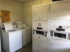 laundry room featuring washing machine and dryer and stacked washer / dryer