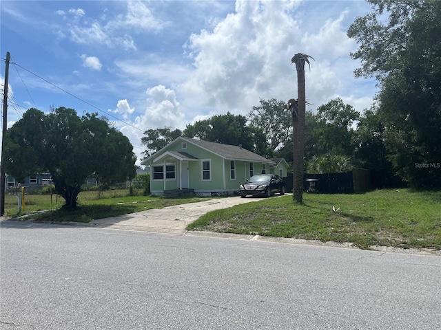 bungalow-style home with a front yard