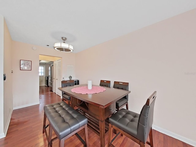 dining space featuring dark hardwood / wood-style floors