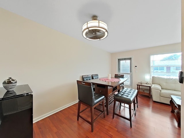 dining space featuring ceiling fan and dark hardwood / wood-style floors