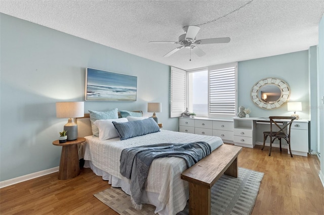 bedroom featuring a textured ceiling, ceiling fan, and light hardwood / wood-style floors