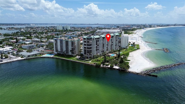 birds eye view of property featuring a beach view and a water view