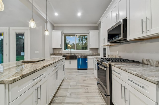 kitchen featuring stainless steel appliances, white cabinets, crown molding, and sink