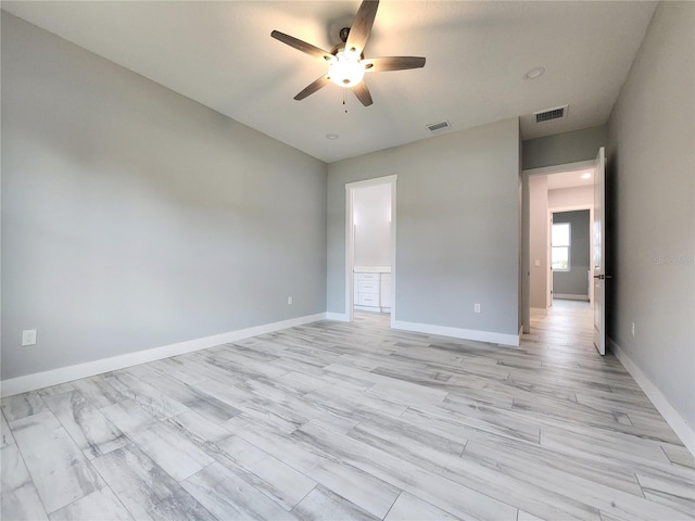 empty room featuring ceiling fan and light hardwood / wood-style flooring