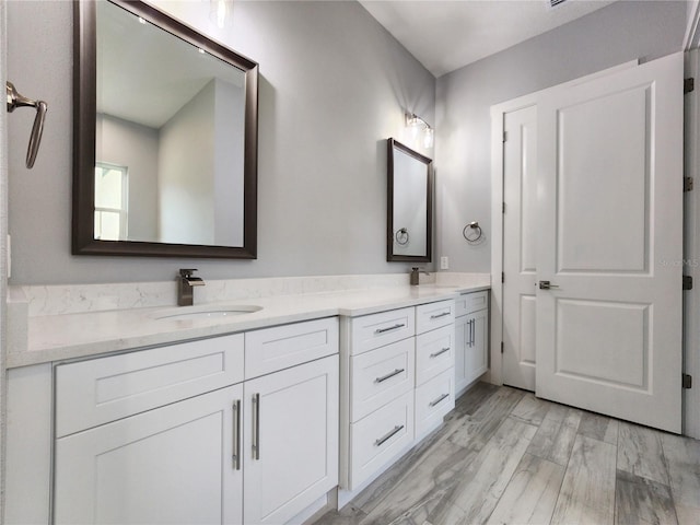 bathroom featuring vanity and hardwood / wood-style flooring