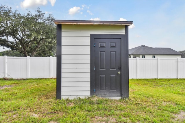 view of outbuilding featuring a lawn