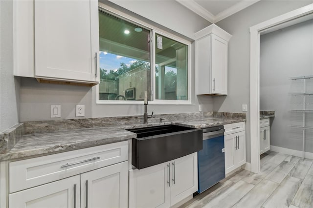 kitchen featuring crown molding, dishwasher, sink, and white cabinets