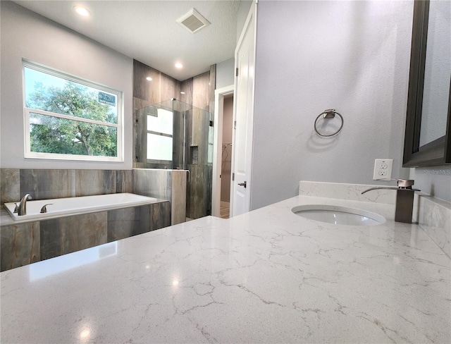 bathroom with vanity and separate shower and tub