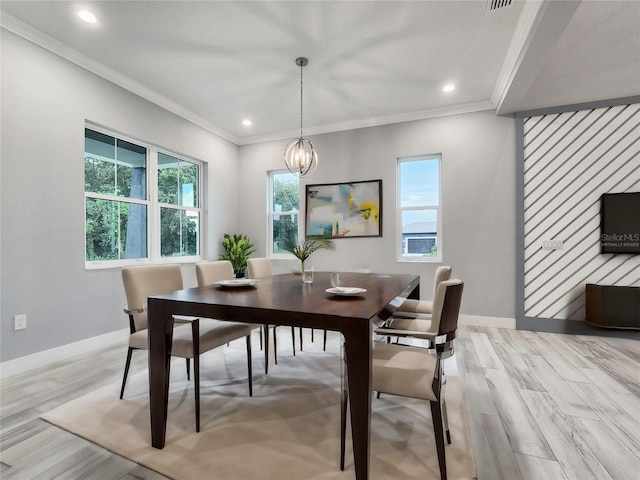 dining room with light hardwood / wood-style flooring, crown molding, and a healthy amount of sunlight