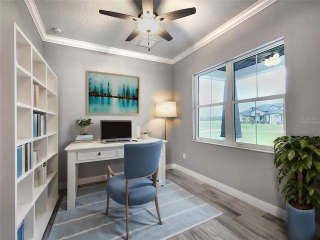 office with ceiling fan, a textured ceiling, ornamental molding, and hardwood / wood-style flooring