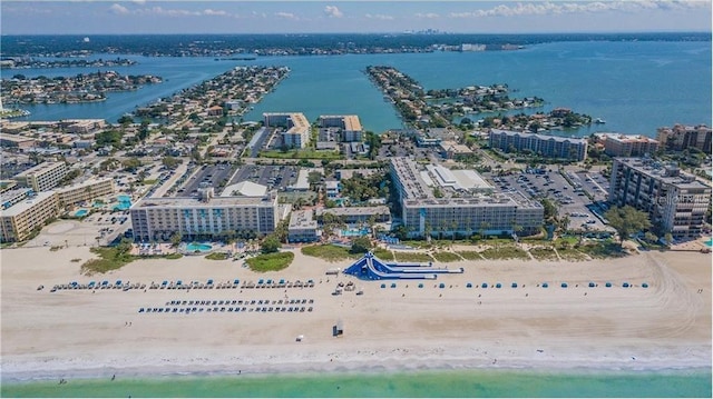 bird's eye view with a water view and a beach view